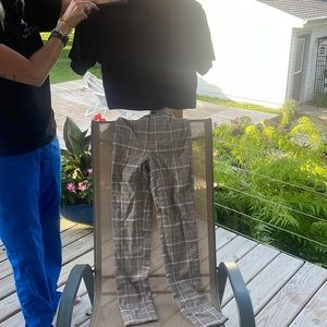 Black top paired with plaid pants